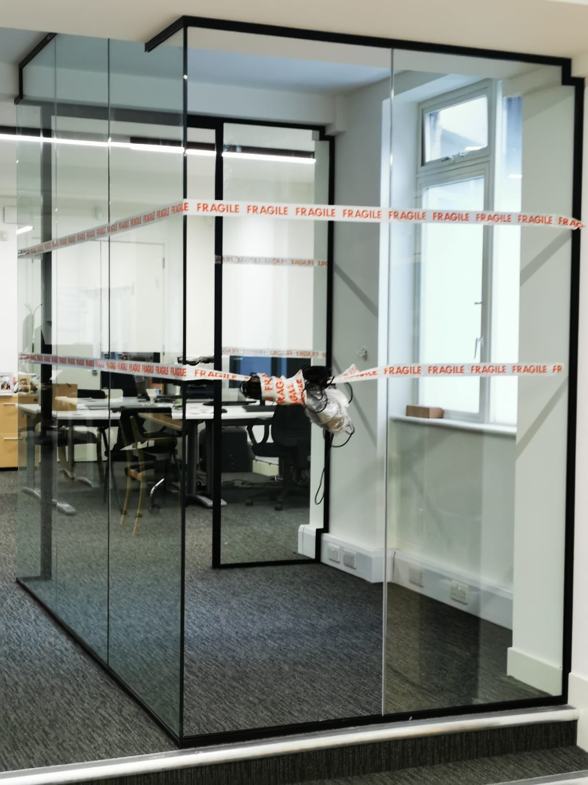 Office fit-out — glazed partition installation, protected during works